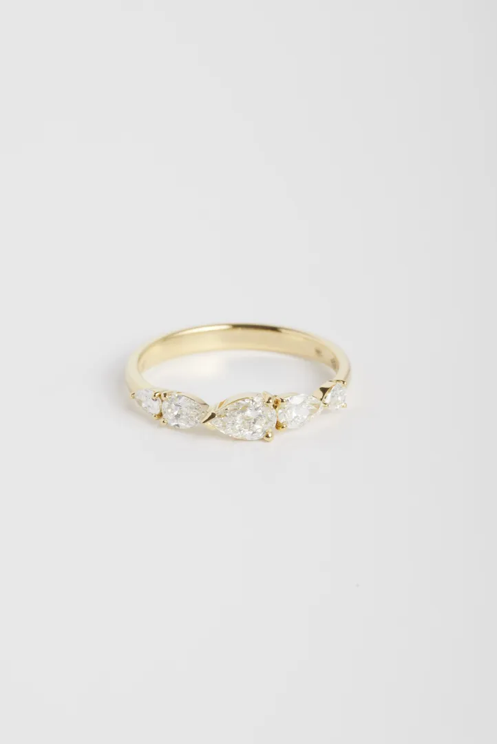 The Ibtissame ring, in 18k yellow gold set with a gradient of pear-cut diamonds. The Ibtissame ring, in 18k yellow gold set with a gradient of pear-cut diamonds.