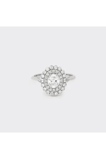 The Aïda ring, in 18k white gold, set with an oval diamond surrounded by brilliant and pear-shaped diamonds.
