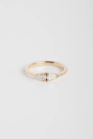 The Elise ring in 18k rose gold set with pear-cut diamonds in a "toi et moi" design.