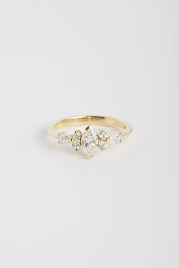 The Ewen M ring in 18k yellow gold set with a marquise-cut diamond and accompanied by brilliant and pear-cut diamonds.