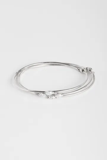 A trilogy of Hana bracelets in 18k white gold set with marquise-cut diamonds.