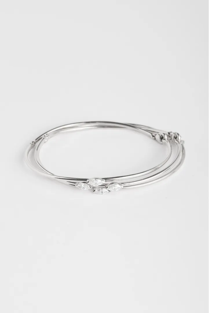 A trilogy of Hana bracelets in 18k white gold set with marquise-cut diamonds. A trilogy of Hana bracelets in 18k white gold set with marquise-cut diamonds.
