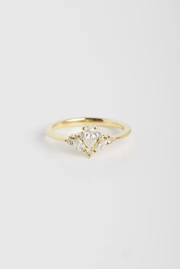 La bague Antoine S en or jaune 750‰ sertie d'un diamant central taille poire de 0.30Ct et accompagné de diamants taille marquise et brillant.