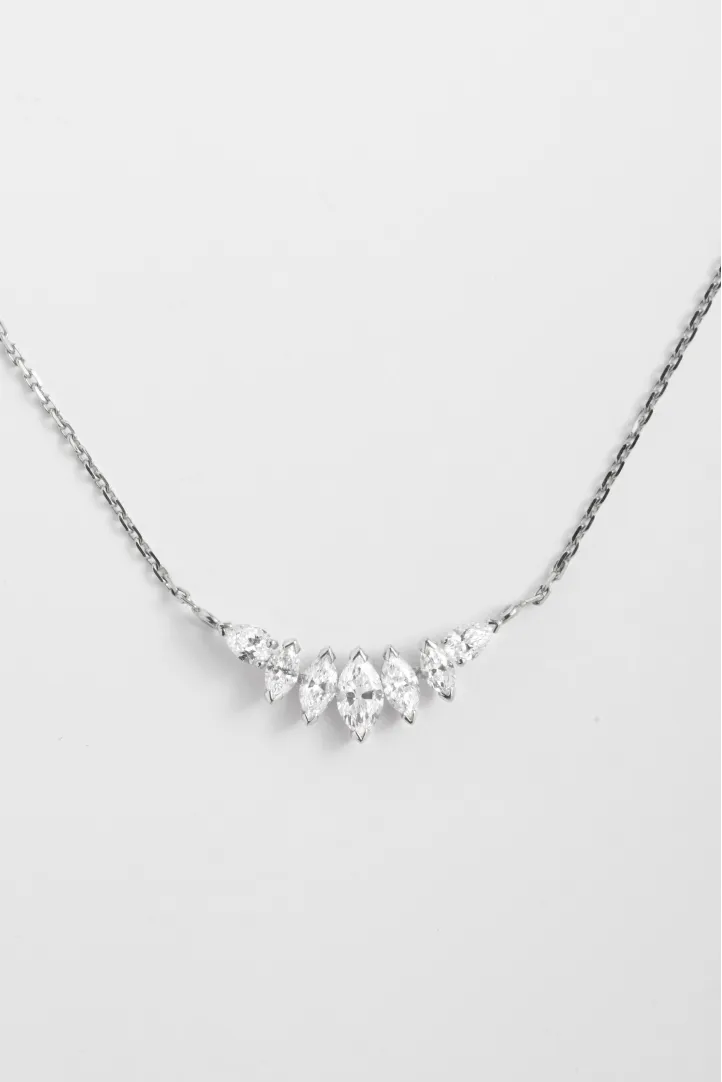 The Romy necklace, in 18k yellow gold, set with a gradient of marquise-cut diamonds and accompanied by pear-shaped diamonds. The Romy necklace, in 18k yellow gold, set with a gradient of marquise-cut diamonds and accompanied by pear-shaped diamonds.