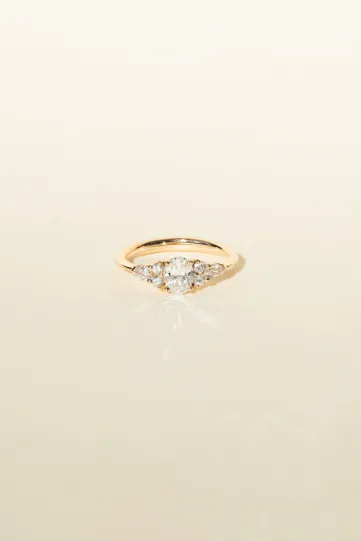 <p>A Julie M ring in 18k rose gold set with an oval diamond and accompanied by pear and brilliant-cut diamonds.</p>