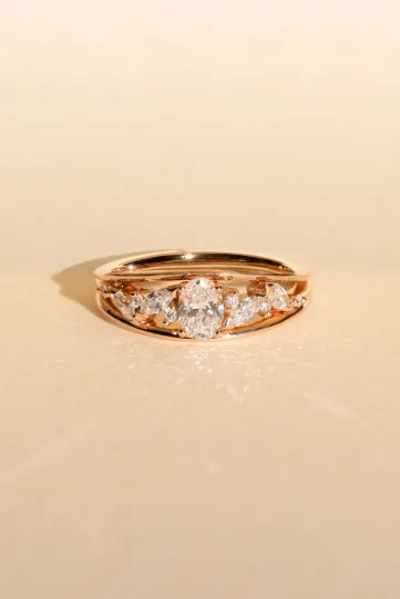 <p>The Mylène ring, in 18k rose gold, set with an oval diamond and accompanied by marquise and brilliant diamonds.</p>