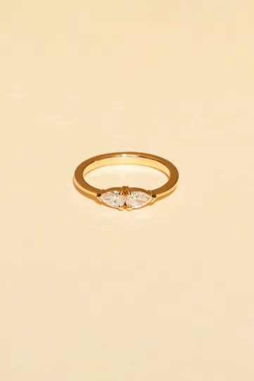 The Elise ring in 18k rose gold set with pear-cut diamonds in a "toi et moi" design.