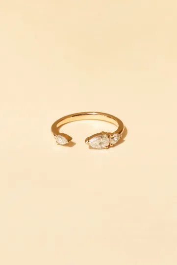 The Gwen S ring in 18k rose gold set with a central pear-cut diamond and accompanied by pear-cut diamonds.