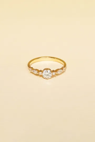 The Prune S ring, in 18k rose gold, set with a brilliant-cut central diamond and accompanied by brilliant and marquise diamonds.