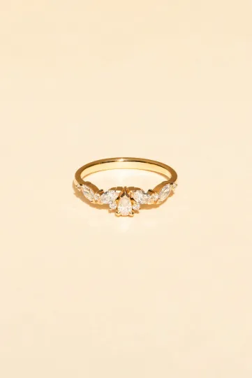 <p>The Rania Poire ring in 18k rose gold set with a pear-cut diamond and accompanied by marquise-cut and brillant-cut diamonds.</p>
