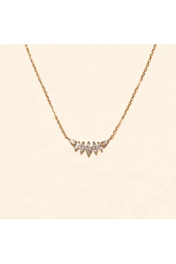 <p>The Romy necklace, in 18k yellow gold, set with a gradient of marquise-cut diamonds and accompanied by pear-shaped diamonds.</p>