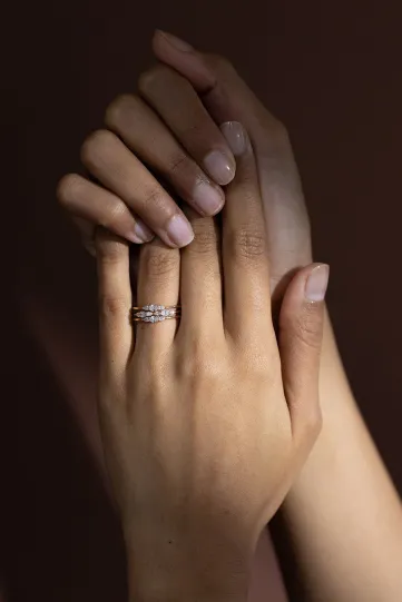 The Lou trilogy, composed of two Lou rings and one Loulou ring in 750‰ yellow gold, set with oval and pear-cut diamonds.