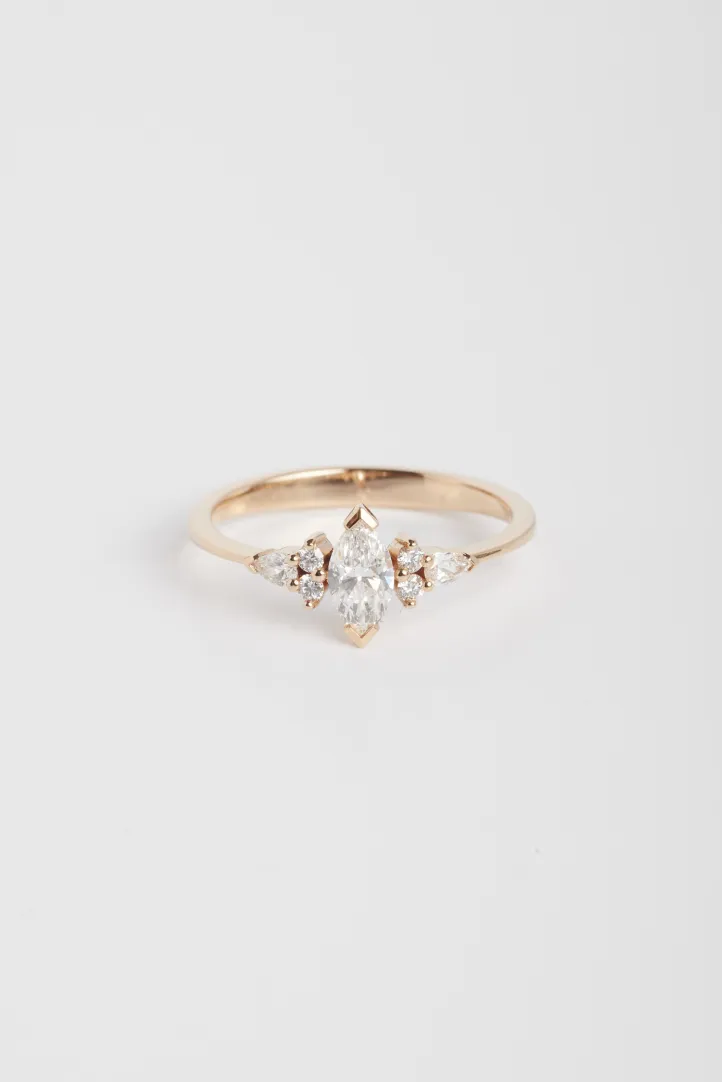 La bague Anne S en or rose 750‰ sertie d'un diamant central taille marquise et accompagné de diamants taille brillant et poire. La bague Anne S en or rose 750‰ sertie d'un diamant central taille marquise et accompagné de diamants taille brillant et poire.
