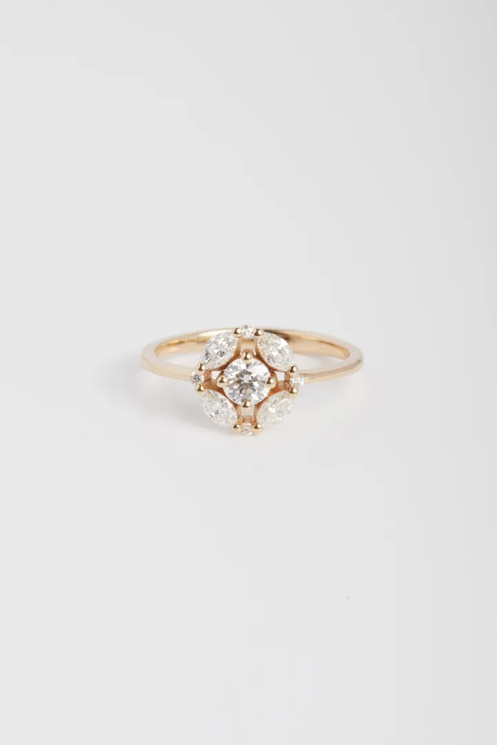 The Rina ring, in 750‰ rose gold, set with a central brilliant-cut diamond and accompanied by marquise and brilliant-cut diamonds. The Rina ring, in 750‰ rose gold, set with a central brilliant-cut diamond and accompanied by marquise and brilliant-cut diamonds.